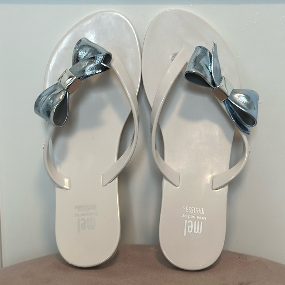 NWOT gorgeous Mel by Melissa flip-flops, brand new! Size 3 in white and silver.